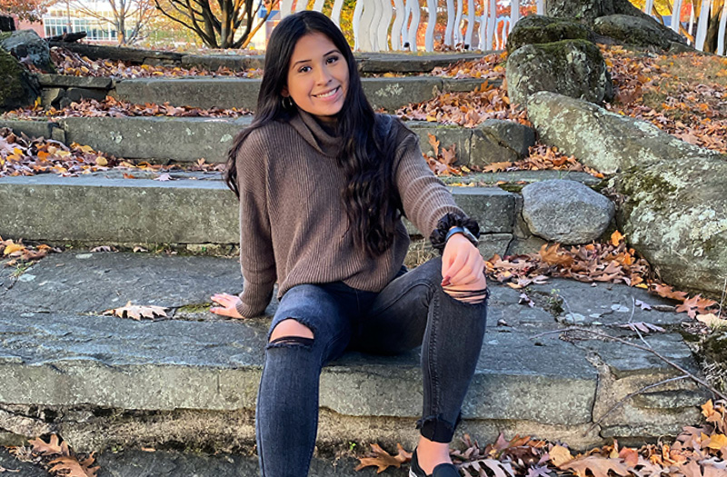 A woman sitting on a stone staircase.